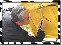 Tom Matano signing cars during Surf 'N' Safari '04 (Photo by Mark Booth)