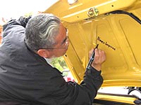 Tom Matano signing cars during Surf 'N' Safari '04 (Photo by Mark Booth)
